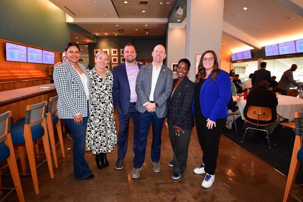 Group of people smiling at the Dodger Stadium Day of Learning hosted by Arkus with the Los Angeles Dodgers Foundation